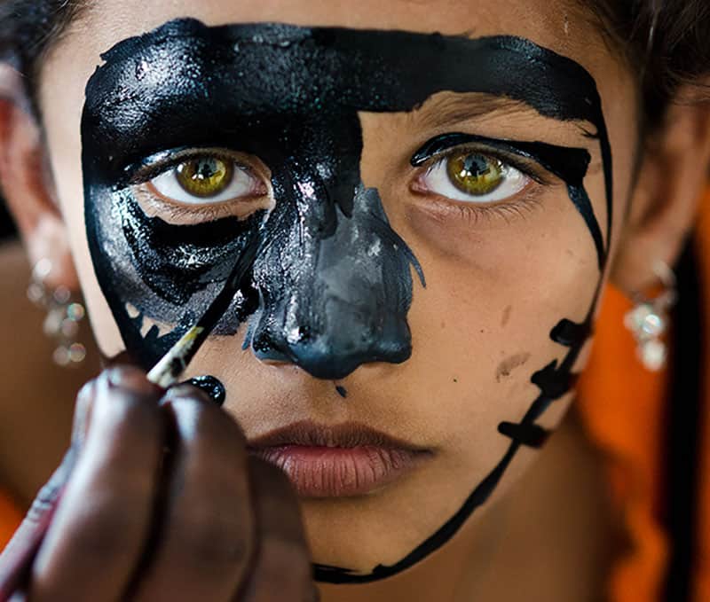 an artist painting a woman's face