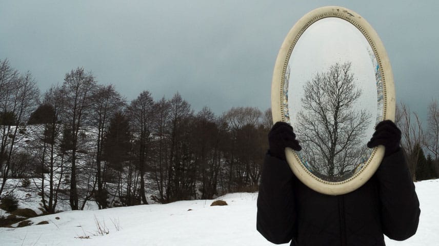 mirror held over face